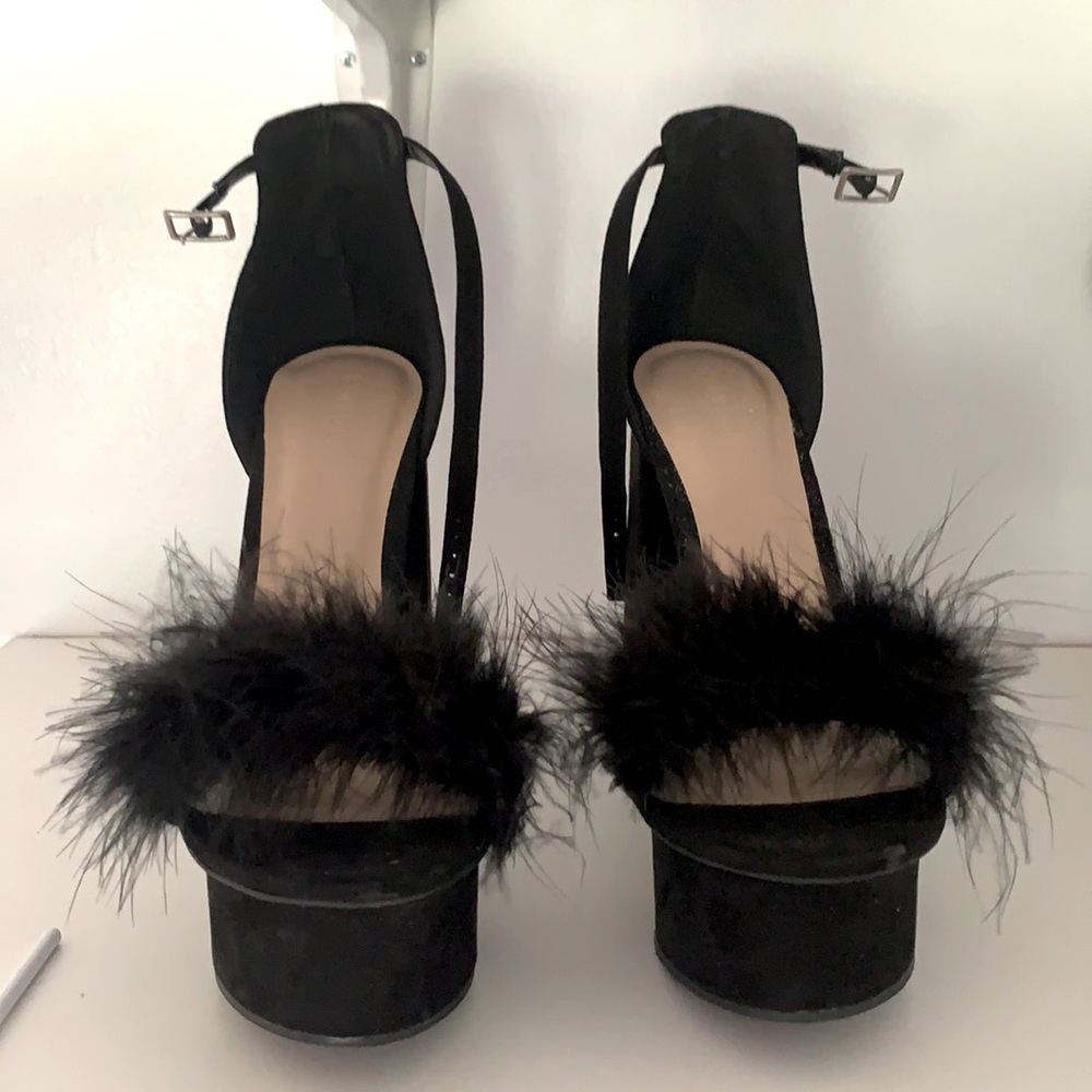 Platform black heels, fathers around the toes.